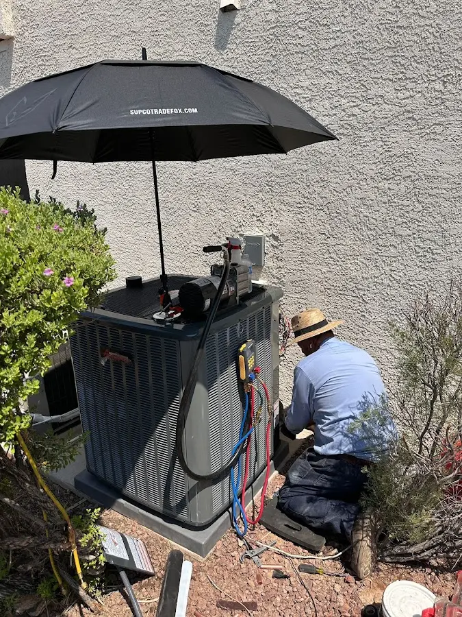 HVAC technician performing outdoor AC maintenance in Culver City