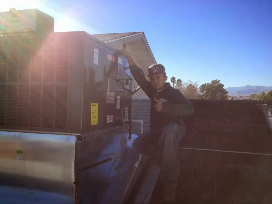 HVAC technician performing AC Tune-Up on a rooftop unit in Culver City